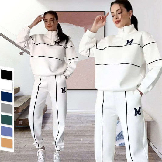 Stylish women's hoodless pullover sweatshirt and matching sweatpants set featuring stripes and logo in white color.